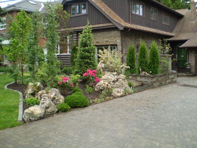 Front yard after landscaping with boulders and flowers